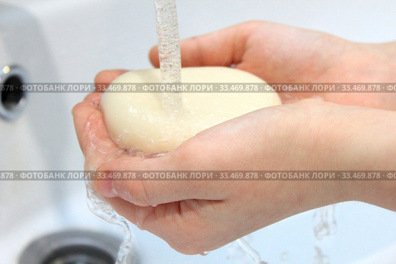 Children's hands holding soap under running water under bathroom sink faucet. Стоковое фото, фотограф Попова Ольга / Фотобанк Лори