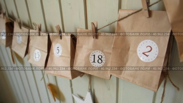 Christmas Advent Calendar. Paper bags, dry fruits, string on white table. Seasonal activity for kids, family winter holidays. Handmade tinkered calendar, natural material. DIY. Soft Focus. Top View. Стоковое видео, видеограф Марина Демидюк / Фотобанк Лори