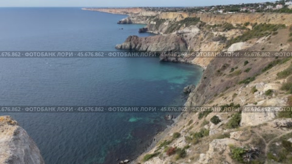 Cliffs Coastline Crimea: Aerial view showcasing scenic coastal landscape, highlighting geological formations and turquoise waters. Стоковое видео, видеограф svetograph / Фотобанк Лори