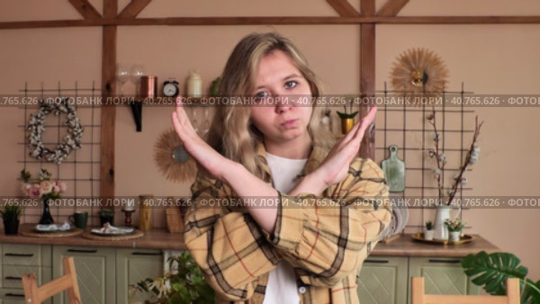 Close-up female portrait young caucasian woman showing prohibition sign crossing arms making refusal gesture negative shaking head dissatisfied serious girl says no refuses demonstrates stop. Стоковое видео, видеограф Сахарова Мария Юрьевна / Фотобанк Лори