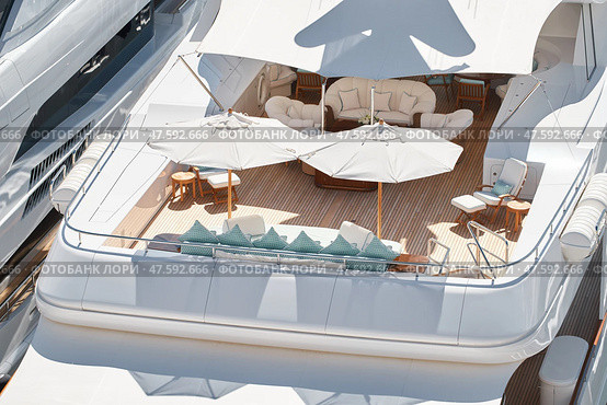 Close up footage of a relaxation area on the open teak deck of an expensive megayacht at sunny day, with awnings stretched over the deck to protect from the sun, wealth life, table and chairs. Стоковое фото, фотограф Vladimir Drozdin / Фотобанк Лори