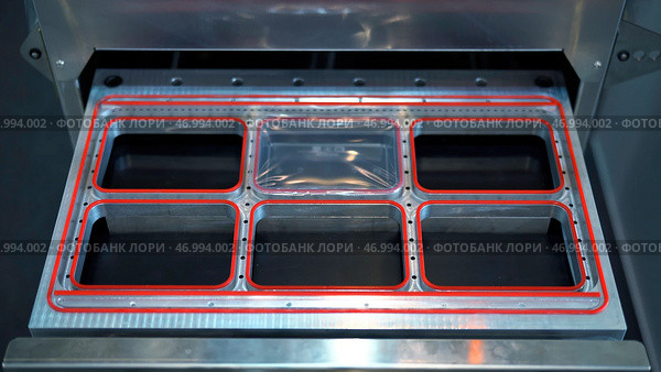Close up of automatic machine for making plastic containers. Стоковое фото, фотограф David Kashakhi / Фотобанк Лори