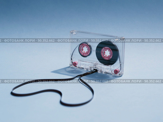 close up shot clear cassette tape gradient background. Стоковое фото, агентство Ingram Publishing / Фотобанк Лори