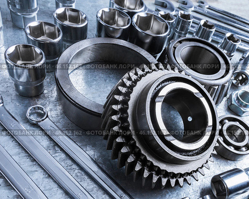 Close-up view of various metal tools and mechanical parts arranged on workbench at a workshop during afternoon. Стоковое фото, фотограф Сергей Толмачёв / Фотобанк Лори