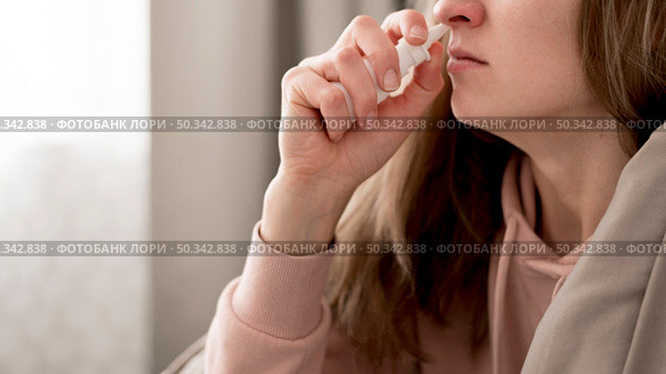 close up woman taking treatment runny nose. Стоковое фото, агентство Ingram Publishing / Фотобанк Лори