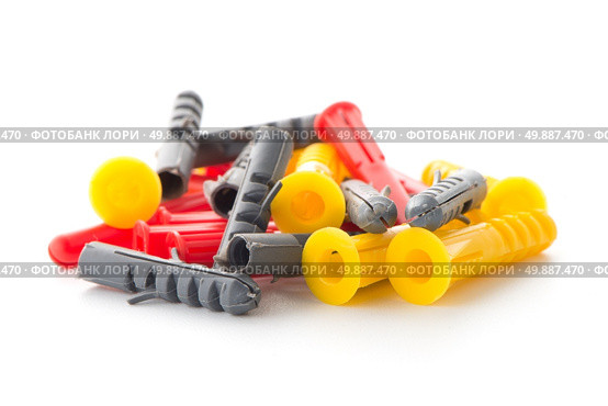Closeup of colorful plastic dowels isolated on white background. Стоковое фото, агентство Ingram Publishing / Фотобанк Лори