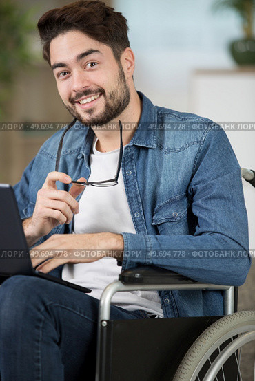 closeup of happy disabled man uses laptop a. Стоковое фото, агентство Ingram Publishing / Фотобанк Лори