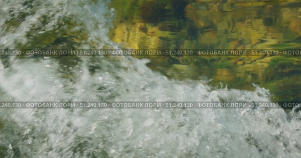 Closeup of splashing river water with visible reflection and motion in Croatia. Стоковое видео, видеограф Ольга Сухарева / Фотобанк Лори