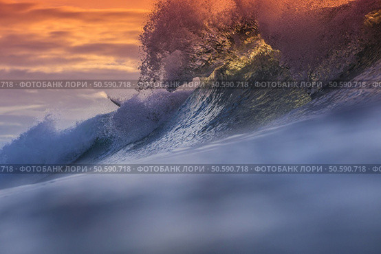 Colored Ocean Wave Falling Down at Sunset Time. Стоковое фото, агентство Ingram Publishing / Фотобанк Лори