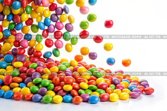 Colorful dragee candies in the assortment on a white background. Various sweets, confectionery and dragees of different shapes and colors. Bright rainbow hues. Стоковое AI-изображение, AI-художник Photojuli / Фотобанк Лори