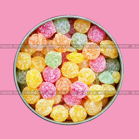 Colorful multicolored sucking sweets Montpensier lollipops in a round tin box isolated on a pink background close-up top view flat lay. Стоковое фото, фотограф Андрей С / Фотобанк Лори