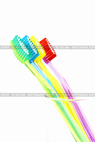 Colorful toothbrush in glass. Стоковое фото, фотограф Gábor Páll / Smarterpix / Фотобанк Лори