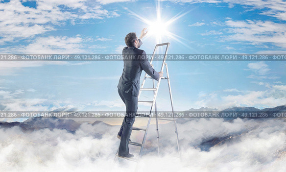 Conceptual picture of young businessman achieving a success. Стоковое фото, агентство Ingram Publishing / Фотобанк Лори