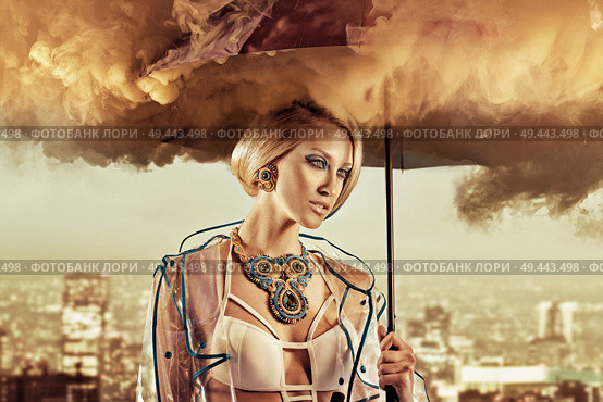 Conceptual portrait of a woman holding a smoky umbrella. Стоковое фото, агентство Ingram Publishing / Фотобанк Лори