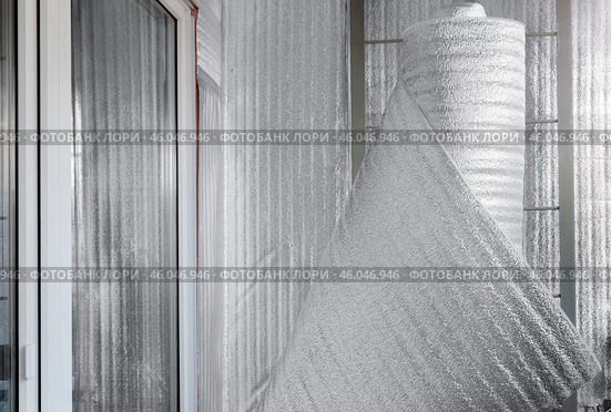 Construction roll insulating material. Folgoizol for insulation and vapor barrier of the floor, walls, ceiling. Covered with a thin layer of aluminum. Стоковое фото, фотограф Дмитрий Кобзев / Фотобанк Лори