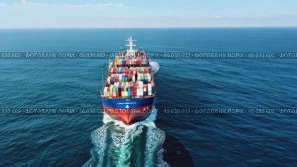 Container cargo Ship Arrival - Aerial View. Containers In Freight Ship. Video above huge colorful container carrier vessel cruising deep blue open ocean sea. Global transportation, logistics business. Стоковое AI-видео, аниматор Марина Демидюк / Фотобанк Лори