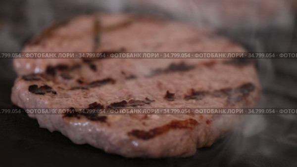 Cooking, barbecue and fast food concept - closeup of burger meat cutlets roasting on brazier grill. Стоковое видео, видеограф Яков Филимонов / Фотобанк Лори