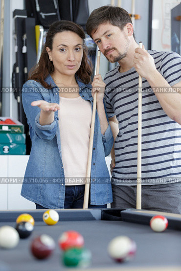 couple by snooker table discussing tactics. Стоковое фото, агентство Ingram Publishing / Фотобанк Лори