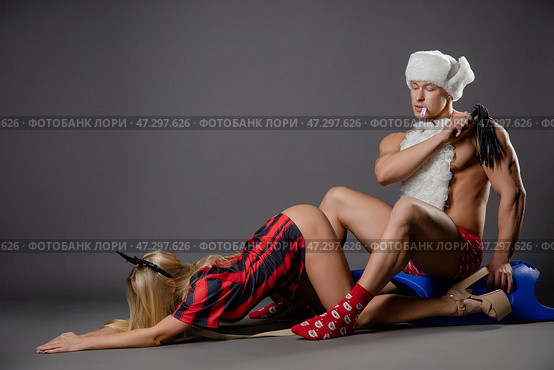 Couple engages in playful roleplay with costumes in a studio setting. Стоковое фото, фотограф Гурьянов Андрей / Фотобанк Лори