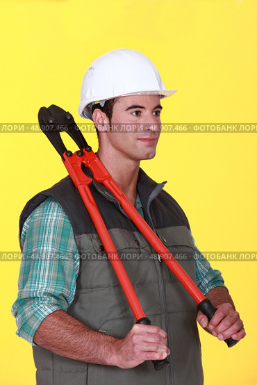 craftsman holding a huge spanner. Стоковое фото, агентство Ingram Publishing / Фотобанк Лори