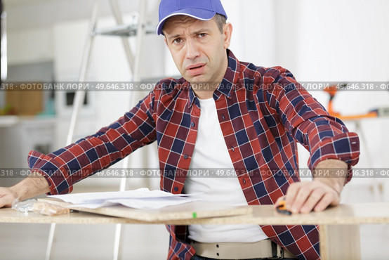 craftsmen man having doubts with confuse face expression. Стоковое фото, агентство Ingram Publishing / Фотобанк Лори