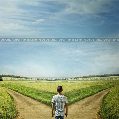Creative concept with a man in front of two roads choosing the correct way. Стоковое фото, агентство Ingram Publishing / Фотобанк Лори