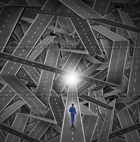 Crisis manager business concept as a businessman walkig through a maze and direction chaos with a mountain of tangled sharp turn roads as a financial metaphor for managing challenging organization situations with courage and expertise. Стоковое фото, агентство Ingram Publishing / Фотобанк Лори