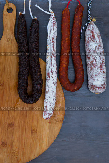Cured meat and sausages hanging a rack. Cured meat and sausages. Стоковое фото, агентство Ingram Publishing / Фотобанк Лори