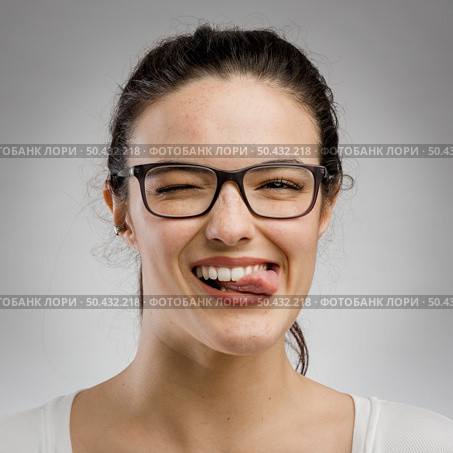 Cute portrait of a woman biting her tongue. Стоковое фото, агентство Ingram Publishing / Фотобанк Лори