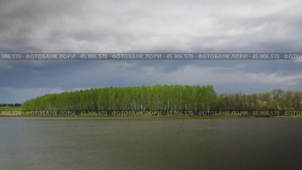 Dark storm clouds fast moving over lake, timelapse. Стоковое видео, видеограф Михаил Коханчиков / Фотобанк Лори