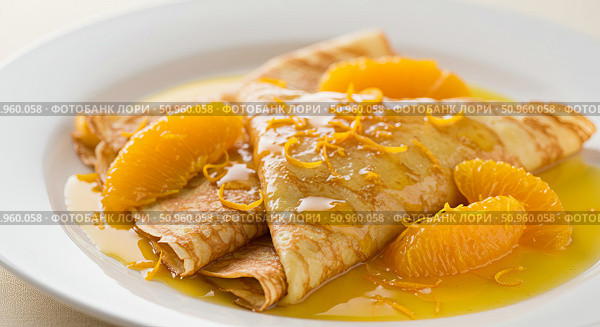 Delicious crepe suzette with orange segments and zest on white plate for breakfast or dessert. Sweet morning meal. Стоковое AI-изображение, AI-художник Анжелика Самсонова / Фотобанк Лори