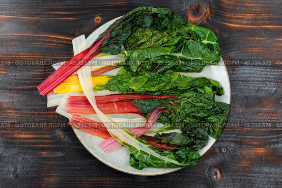 Delicious healthy stewed chard leaves on a plate. Healthy breakfast, top view. Sauteed swiss chard, top view. Стоковое фото, агентство Ingram Publishing / Фотобанк Лори
