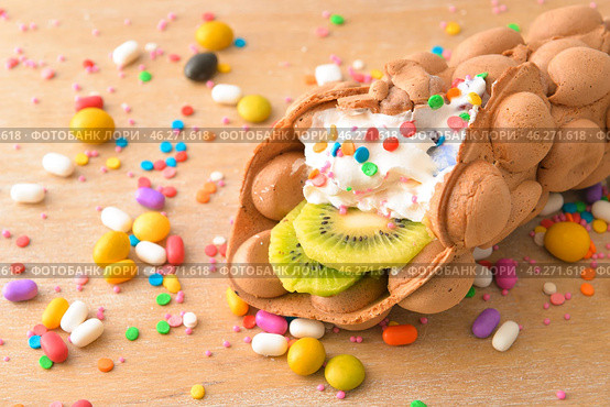 Delicious sweet bubble waffle on wooden board. Стоковое фото, фотограф Pixel_shot / Фотобанк Лори