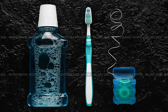 Dental floss with tooth brush and rinse on dark background. Стоковое фото, фотограф Pixel_shot / Фотобанк Лори