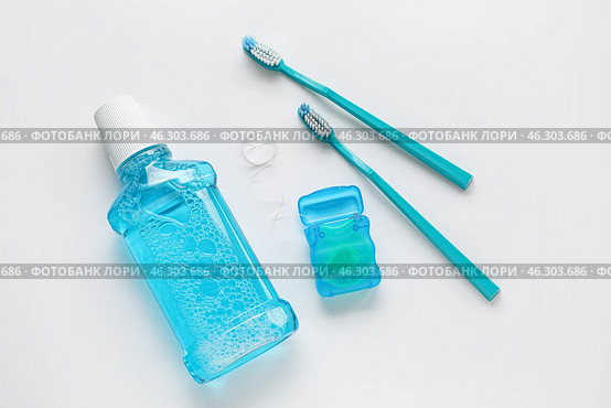 Dental floss with tooth brushes and rinse on white background. Стоковое фото, фотограф Pixel_shot / Фотобанк Лори