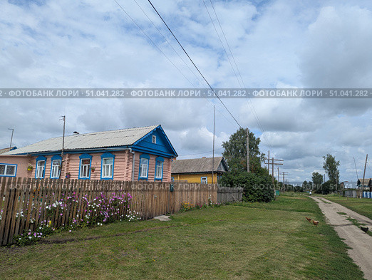 Деревенский дом с цветами у забора летом. Стоковое фото, фотограф Юлия Юриева / Фотобанк Лори