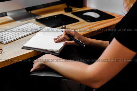 designer girl at work at the table draws on the tablet, close the keypad, printer, computer. Стоковое фото, агентство Ingram Publishing / Фотобанк Лори