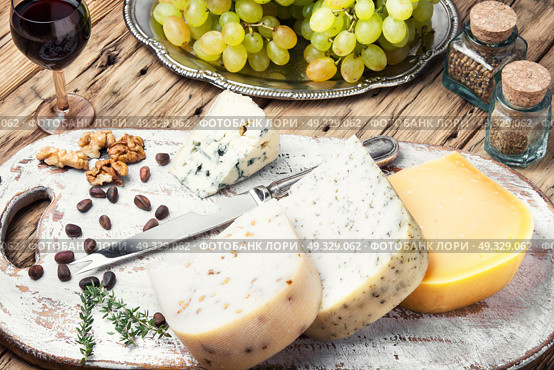 Different kinds of cheeses. aromatic Swiss cheese and a glass of grape wine. Стоковое фото, агентство Ingram Publishing / Фотобанк Лори