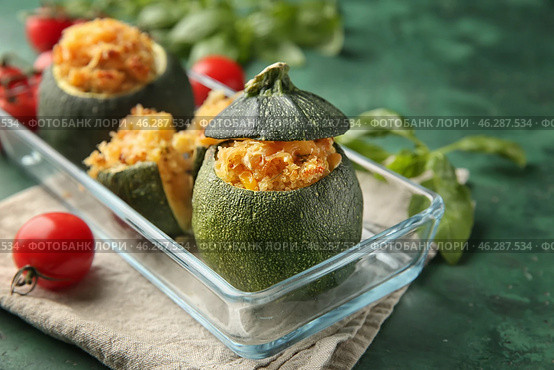 Dish with quinoa stuffed zucchinis on green table, closeup. Стоковое фото, фотограф Pixel_shot / Фотобанк Лори