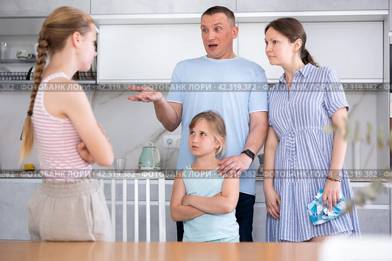 Displeased mother and father reprimanding eldest teenage daughter. Стоковое фото, фотограф Яков Филимонов / Фотобанк Лори