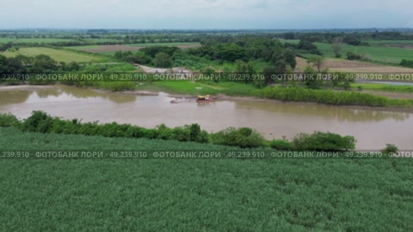 Dredging Machinery Operating in the Cauca River Seen From Drone. Стоковое видео, видеограф ALEJANDRO PEREZ ALVARES / Фотобанк Лори