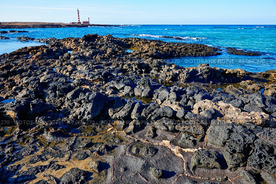El Cotillo beach and Toston lighthouse at Fuerteventura Canary Islands. Стоковое фото, агентство Ingram Publishing / Фотобанк Лори