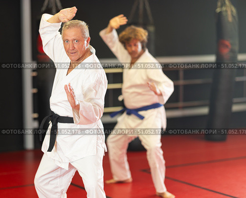 Elderly black‑belt practicing kata in dojo. Стоковое фото, фотограф Яков Филимонов / Фотобанк Лори