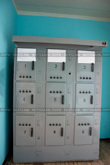 Electrical cabinet showing fuses and switches in room with turquoise wall. Стоковое фото, фотограф Андрей Знаменский / Фотобанк Лори