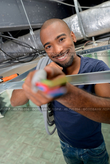 Electrician showing us some wiring. Стоковое фото, агентство Ingram Publishing / Фотобанк Лори