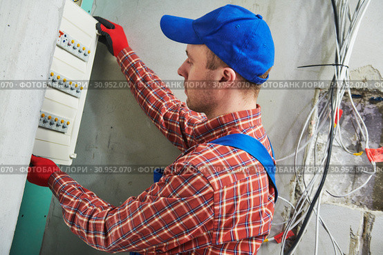 Electrician works with pliers in switchbox. current breaker installation. Стоковое фото, фотограф Дмитрий Калиновский / Фотобанк Лори