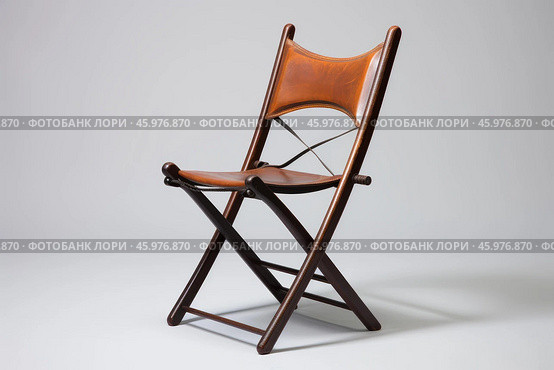 Elegant folding chair with brown leather seat and backrest on plain background. Стоковое AI-изображение, AI-художник Иван Рябоконь / Фотобанк Лори