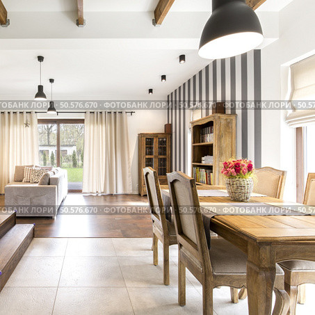 Elegant house interior with spacious dining hall and wooden vintage furnitures. Стоковое фото, агентство Ingram Publishing / Фотобанк Лори