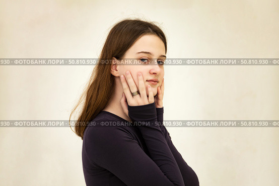Emotive Teen Actress Expresses Deep Feelings in an Indoor Setting With Artistic Flair. Стоковое фото, фотограф Aleksandr Golubev / Фотобанк Лори