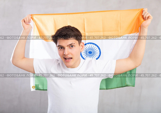 Energized,active male spectator holds national flag of India in hands and chants popular slogan. Стоковое фото, фотограф Яков Филимонов / Фотобанк Лори